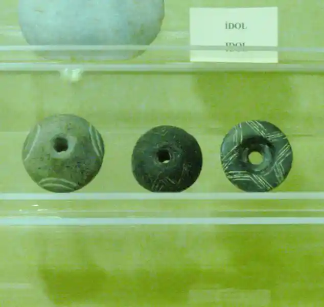 Pre-Christian crosses engraved on stones with holes in the center Ephesus Izmir. Beycesultan middle bronze age finds dated 1900-1450 BC